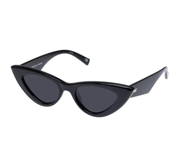 A packshot: black cat-eye sunglasses cut out on a dark backdrop, three-quarter view