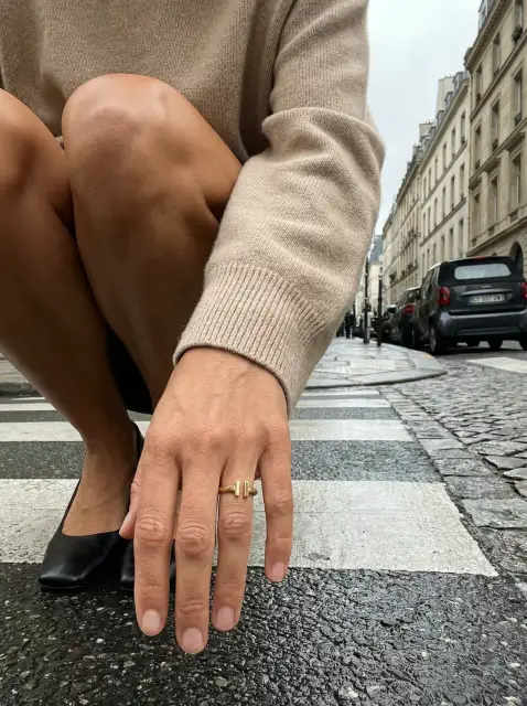 The ring worn on a hand on a Paris crosswalk, generated — a listing hero