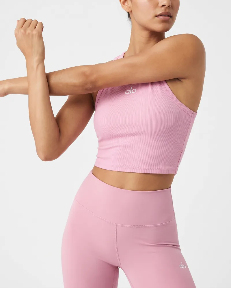 A pink activewear set in a studio stretch, generated from two cut-outs