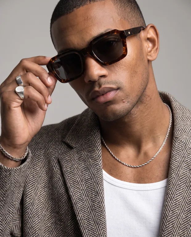 The same tortoise frame worn by Malik, a cast model