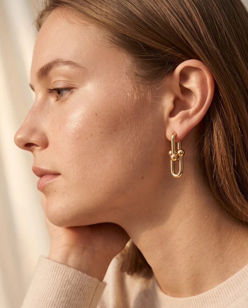 The same gold link earring worn in profile, generated