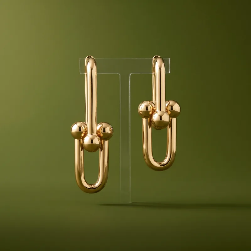 The same earrings on a green backdrop, product-only, generated
