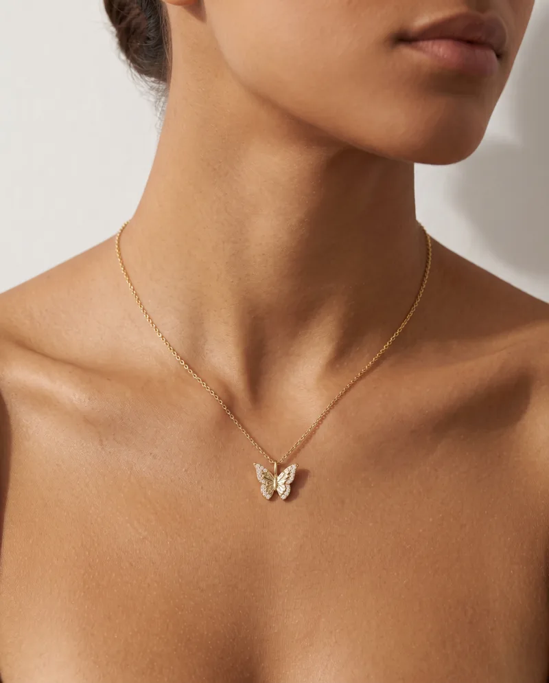 The same butterfly pendant worn at the collarbone, generated