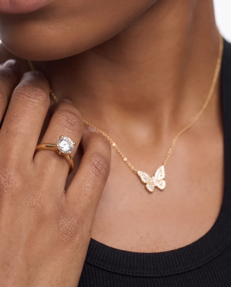 The same scene re-shot closer: pendant, ring and hand