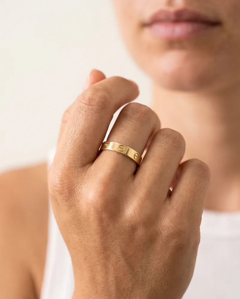 A gold band worn on a hand, generated from a cut-out
