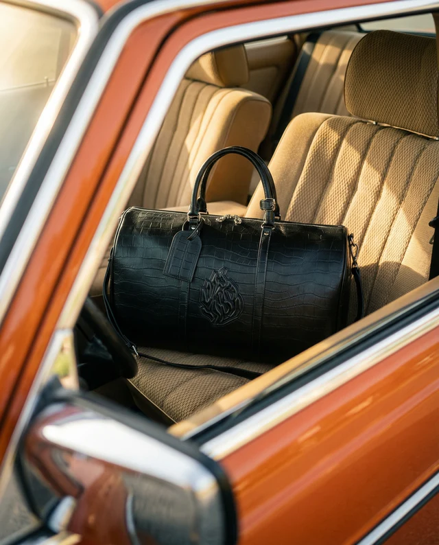 The same duffle bag, generated in a Recipe built around it: on the tan seat of a vintage car